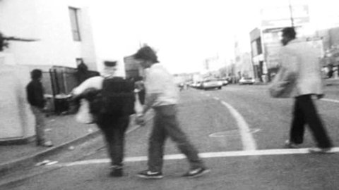 LOS ANGELES, CALIFORNIA - October 1, 1986:  Vintage super 8 driving shot in Los Angeles's urban downtown skid row district.