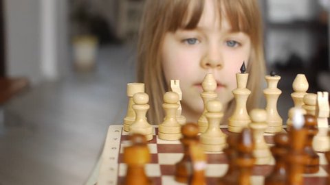 Beautiful little girl learns to play chess 5