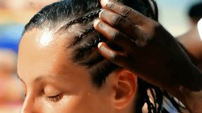 Traditional African hairstyles on white women, Black woman weaves traditional Afro hairstyle on white women, Video clip