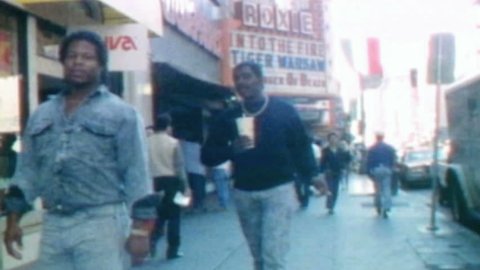 LOS ANGELES, CALIFORNIA - October 11, 1988:  Vintage super 8 moving time lapse of downtown LA's historic Broadway theater district.