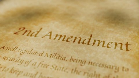 Scrolling text on an old paper background of the contents of the 2nd amendment to the United States Constitution that states the right of citizens to bear arms.