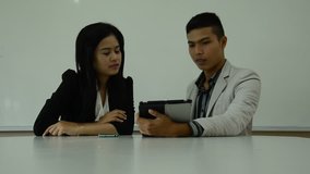 young business couple working with digital tablet.