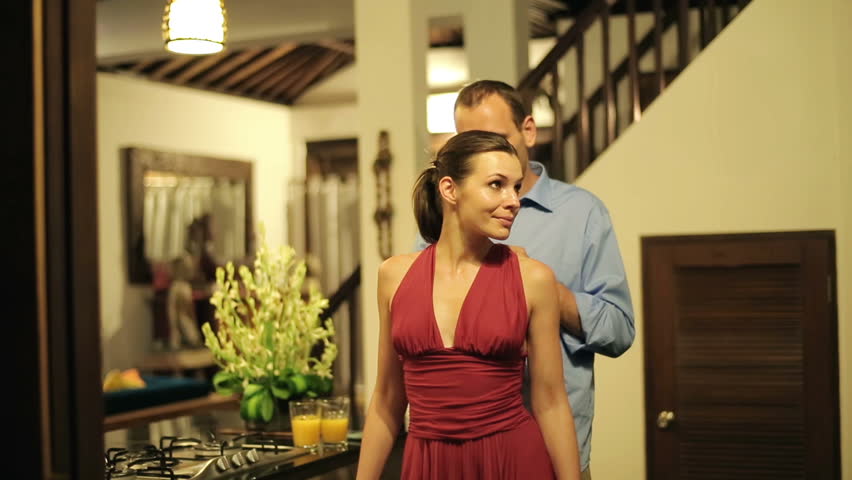 Man helping woman with dress, preparing before party at home

