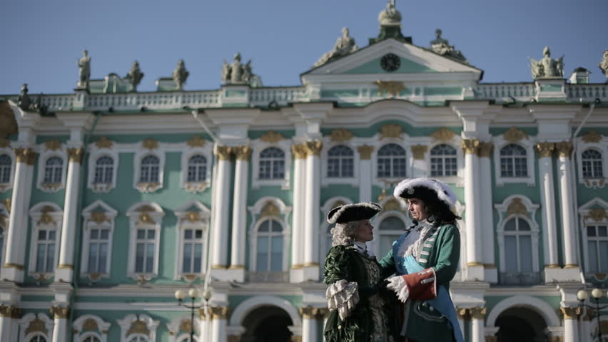 The first emperor of Russia Peter I hugs his beloved Catherine I against the background of the Winter Palace. Long shot.
