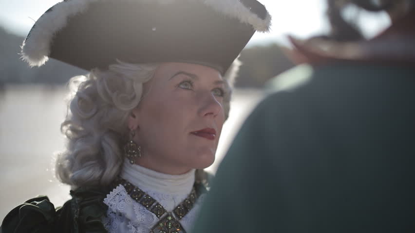 The first emperor of Russia Peter I hugs his beloved Catherine I. Close up at sunset