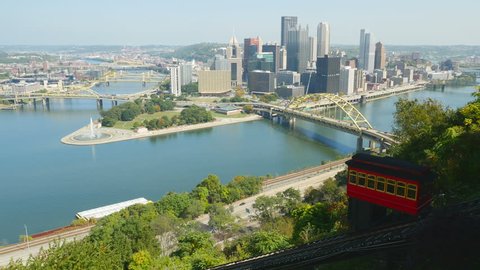 The Duquesne Incline descends Mt. Washington with a view of downtown Pittsburgh, Pennsylvania, at the confluence of the Allegheny and Monongahela Rivers, in the background.