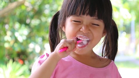 Cute Asian Little Girl Brushing Teeth 