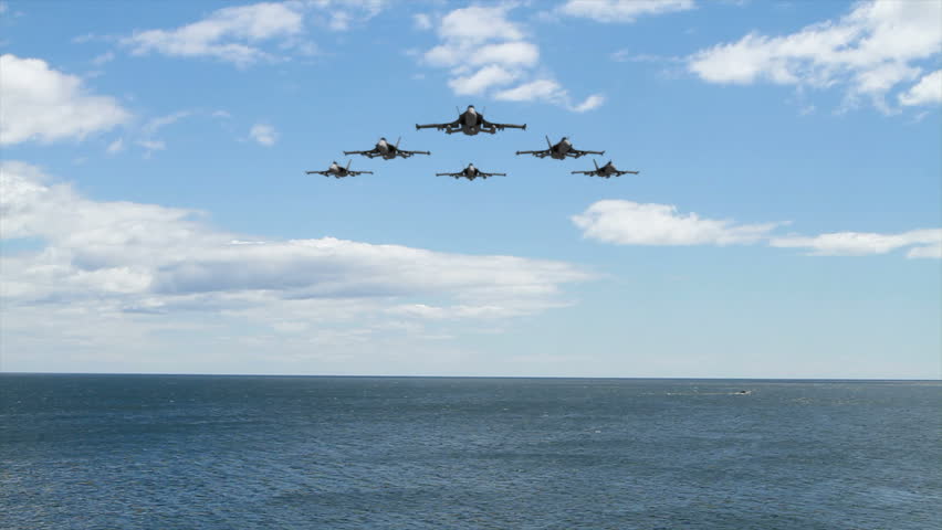 F18 Squadron flying over the ocean at low altitude. (3D Animation)