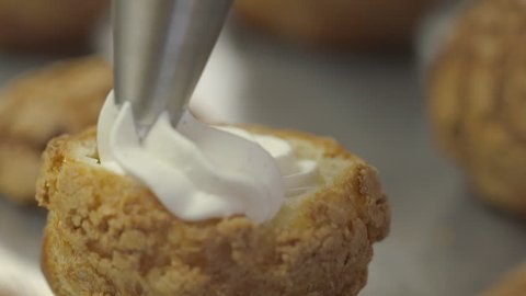 filling pastry with a whipped cream