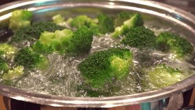 Broccoli in a pot with boiling water (close-up footage)