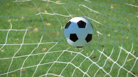 Football soccer ball goal into net slow motion 