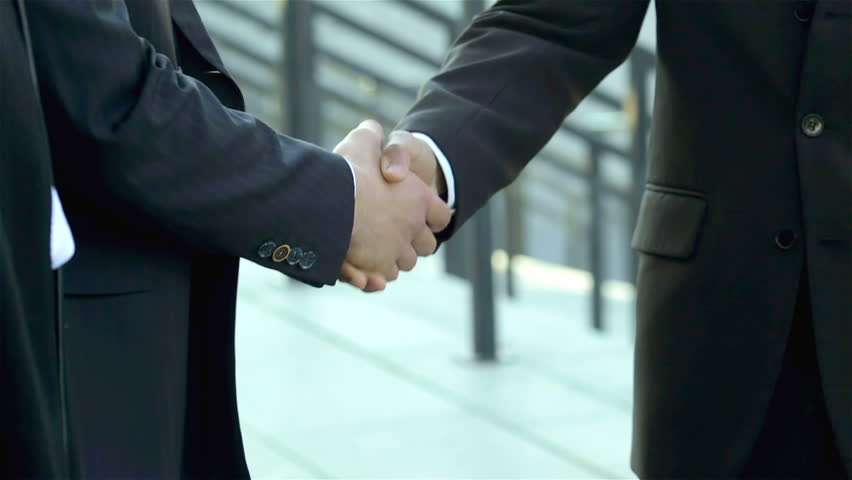 Welcoming new partners. Group of smiling business people in formal clothes found on the street. Handshake, invite. | Shutterstock HD Video #7518265