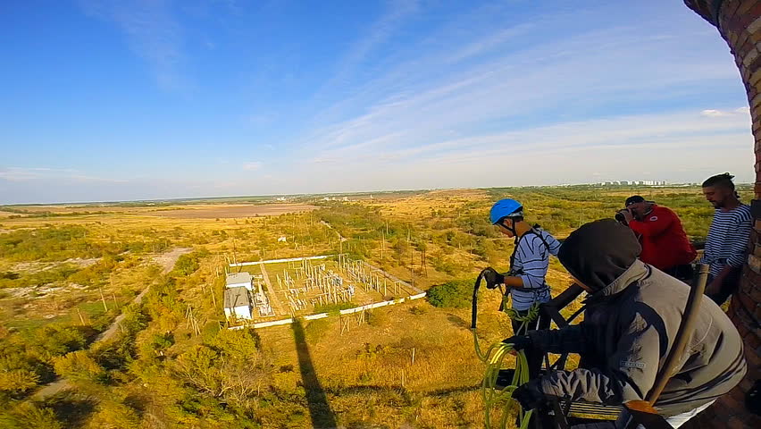 ropejump from the old factory chimneys in Krasnodar, a height of 80 m amplitude coast 60 m hangs 20 meters above the ground on a system of climbing ropes
