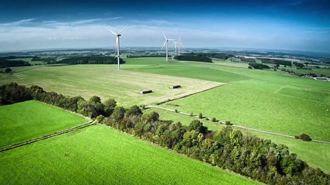 Aerial view of summer countryside with agricultural fields and wind turbines. Full HD, 1080p, 60FPS
