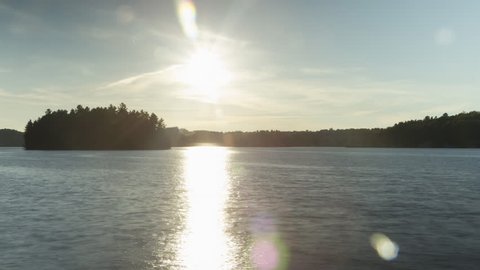 Day to Dusk at Lake Rosseau. Timelapse.
 Timelapse clip assembled and rendered from hi-res stills. Sun going down from daytime to dusk. Lake Rosseau, Muskoka, Ontario, Canada.
