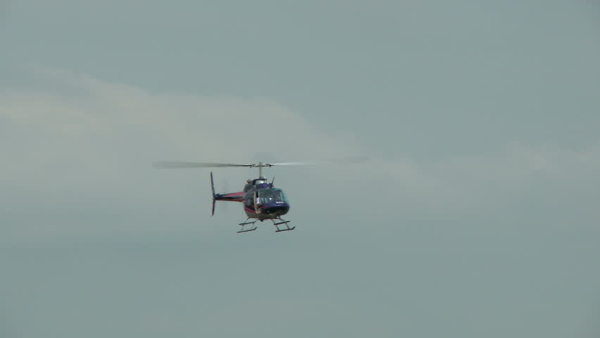 A Bell Jet ranger helicopter in flight approaching to land
