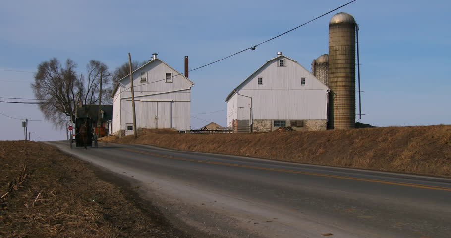 An Amish horse cart travels along a road in rural Pennsylvania.