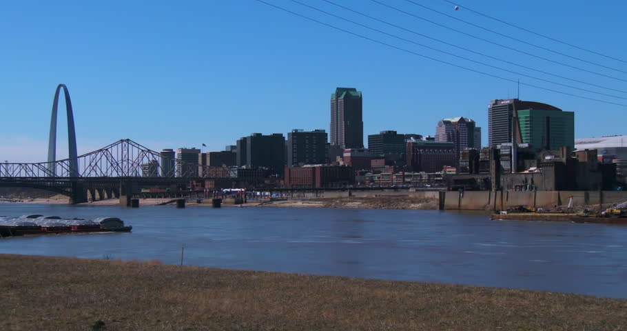 The city of St. Louis by day with Mississippi River foreground.