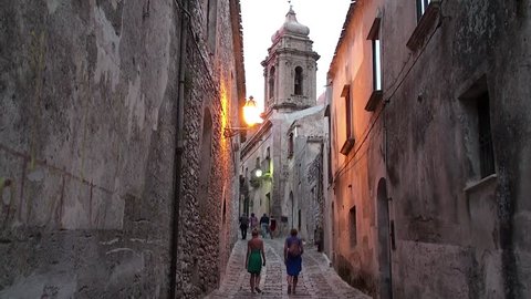 Tourists on the cobbled streets of the medieval Erice city. Sicily, Italy.