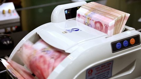 Hundred RMB banknotes in the counting machine.