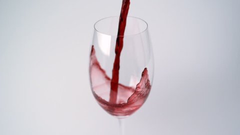 Pouring red wine into glass shooting with high speed camera and motion control.