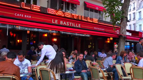 PARIS, FRANCE - CIRCA 2014 - A classic Paris outdoor cafe with waiters serving.