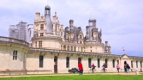CHAMBORD, FRANCE - CIRCA 2014 - Bicyclists ride in front of the beautiful chateau of Chambord in the Loire Valley in France.
