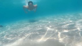 Young woman diving in beautiful blue sea, Diving in the exotic seas, Video clip