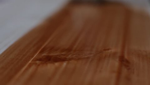 HD video of painting the wood with brown varnish. Extreme close up.