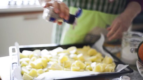 close up of woman housewife hands cooking baked potatoes