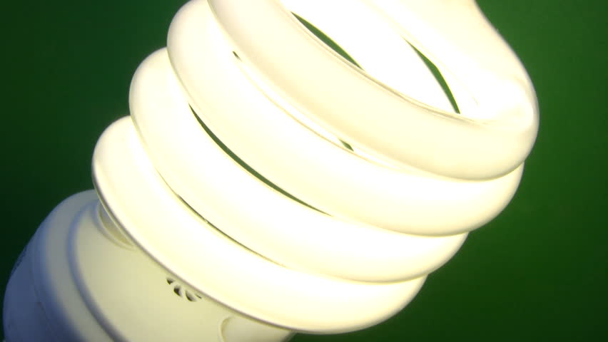 Extreme close up of white compact fluorescent bulb turning off and on