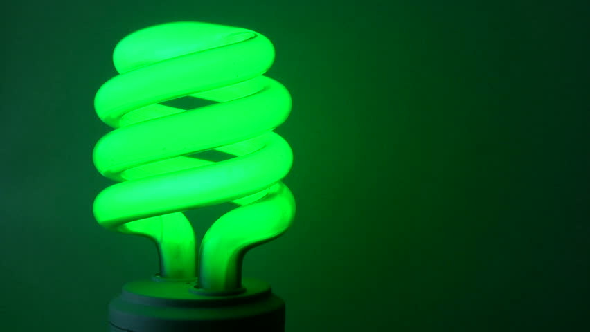Green compact fluorescent bulb turns off and on, space for copy