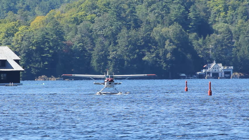 Seaplane taxiing on the lake. Steady shot on tripod. Zoom lens with heat shimmer. Lake Rosseau, Muskoka, Ontario.