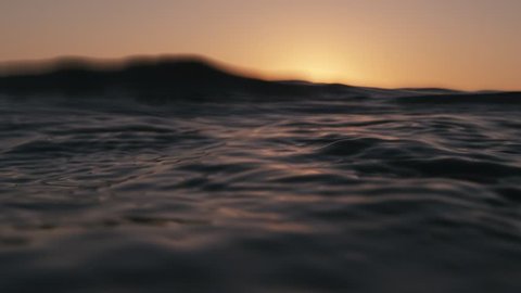 Sea surface from underwater at sunset in slow-motion. Shot on RED Cinema Camera in 4K, crop, rotate and zoom easily. H264 codec High bit rate.