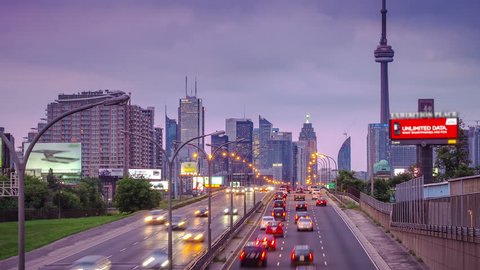 Highway rush hour traffic with Toronto skyline in time-lapse