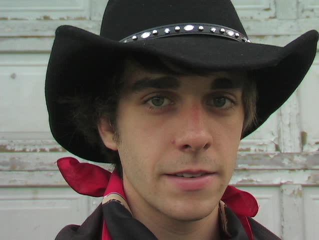  A COWBOY TIPS HIS HAT SHOWING SOME WESTERN HOSPITALITY.