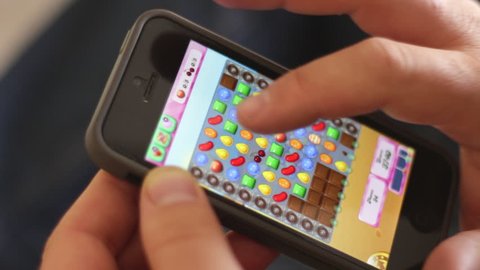 Tel-Aviv, ISRAEL - MAY 1: Playing Candy Crush game on iPhone 5,  on May 1, 2014 in Jerusalem, Israel. Candy Crush Saga is a match-three puzzle video game.