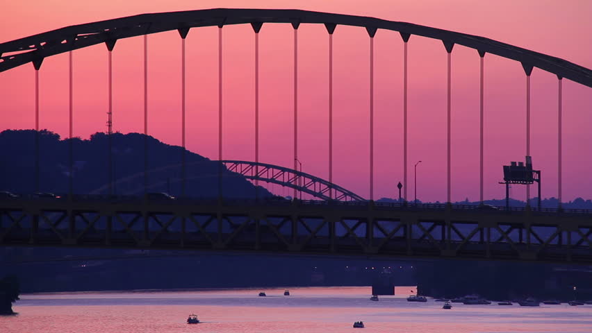 Traffic passes over the Fort Pitt Bridge during dusk in Pittsburgh, PA as
