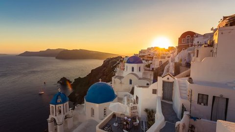 People watching sunset over beautiful town of Oia on the Island of Santorini, Greece