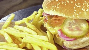 Chickenburger as seamless loopable 4K close-up footage (with french fries)