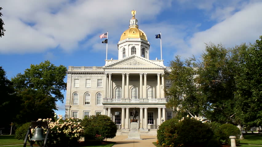 The state house capital building of New Hampshire is located in the city of Concord, NH, USA with surrounding grounds.