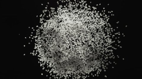 White powder/particles fly after being exploded against black background. Shot with high speed camera, phantom flex 4K. 4K 30fps. Slow Motion.