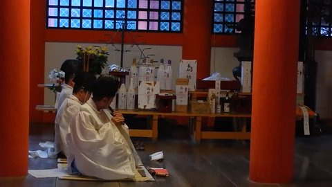 MIYAJIMA, JAPAN - OCTOBER 9:Shinto priests at Itsukushima Shrine at October 9, 2014 in Miyajima, Japan. Miyajima is a shinto holy site and listed in the World heritage of UNESCO.