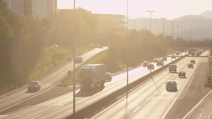 SLOW MOTION: Highway traffic at sunset