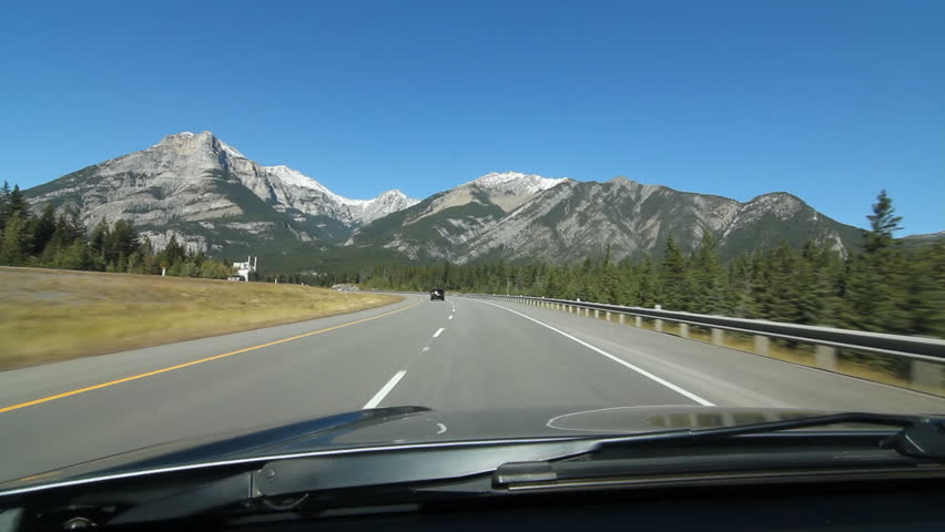 Driving through the mountains on Trans Canada Hwy 1, Banff National Park,  Alberta, Canada. Note some small smudges on windshield.

