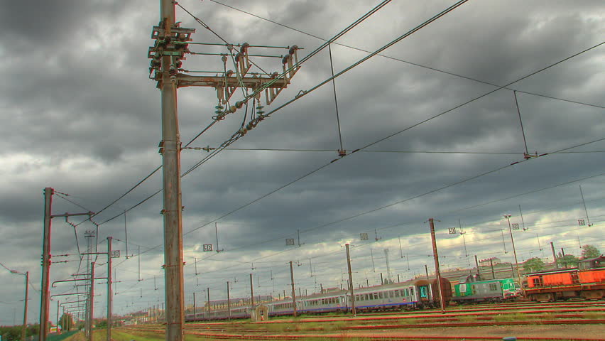 Clouds rolling over industrial trains station, HD time lapse clip, high dynamic