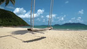 Swing on the shore of a beautiful island. Video with stereo sound