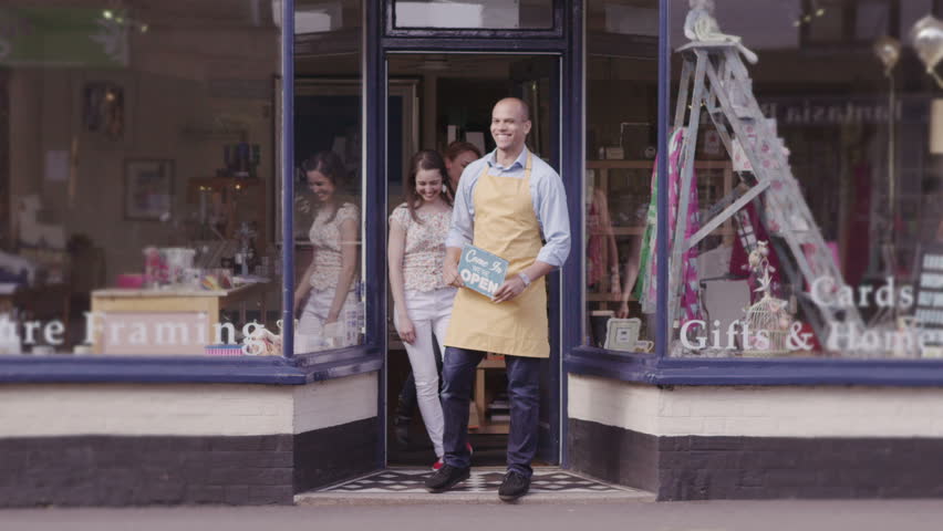 Customers browsing and shopping in local gift store. Purchasing products and goods from shop keeping in small business store.