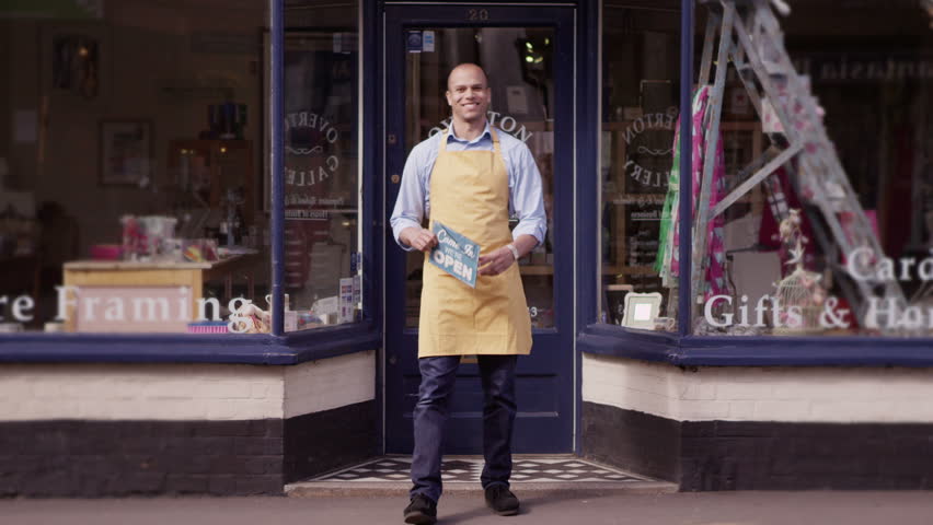 Customers browsing and shopping in local gift store. Purchasing products and goods from shop keeping in small business store.