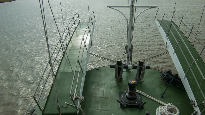 Onboard Mississippi River Steamboat Approaching New Orleans Louisiana Tilting Up from the Water Surface towards the Buildings of Downtown and French Quarter on the Horizon